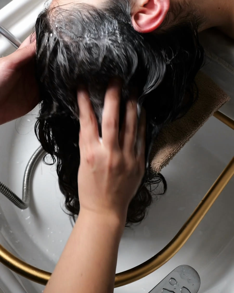 Scalp wash and massage over a head spa basin